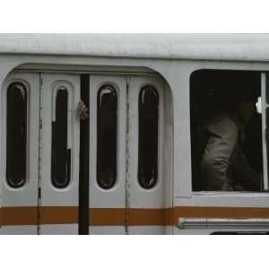  A Mans Hand Hangs out of a Closed Door on a Crowded Bus 