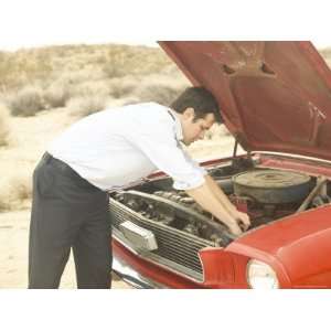 Male Young Adult in Front of Engine of Broken Down Car Photographic 