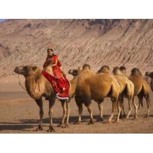  China, Xinjiang Province, Turpan, Uighur Girl Riding on 