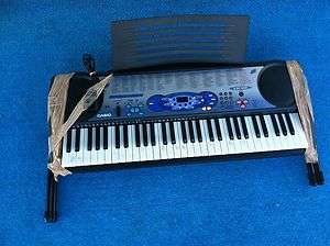CASIO LK 40 KEYBOARD SYNTHESIZER with MIDI, STAND. MUSIC RACK 