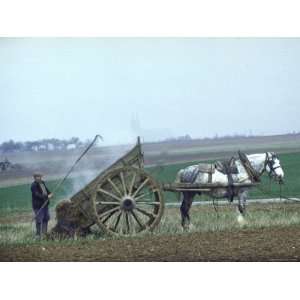  French Farmer Laying Compost on His Field from a Cart 